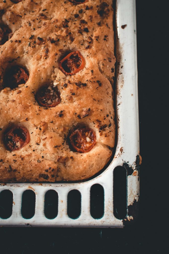 Traditional Italian homemade focaccia with tomato and oregano.